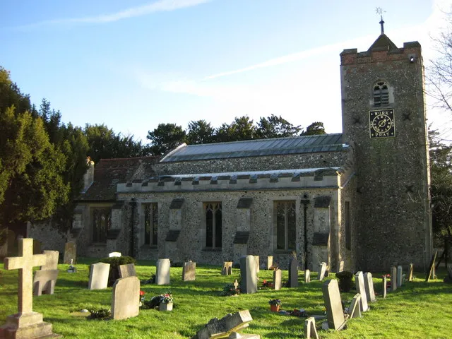St Mary the Virgin parish church, Sheering, Essex, seen from the north. The tower clock has dials on the north and west sides. The dial on this north side reads "Work and Pray".