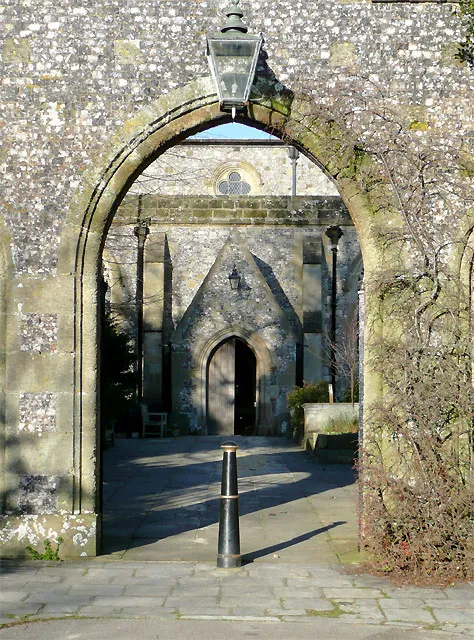 St Nicholas Church gateway, Arundel, West Sussex It is interesting to look at the symmetrical aerial view of the main building on the Googlemap satellite image link on this page. This is a rare example of a church building that is currently divided into two places of worship; the eastern half being the Catholic Fitzalan Chapel and this, the western half being the Anglican Church of St Nicholas. The whole Perpendicular Gothic building was originally built in 1380. http://en.wikipedia.org/wiki/Fitzalan_Chapel