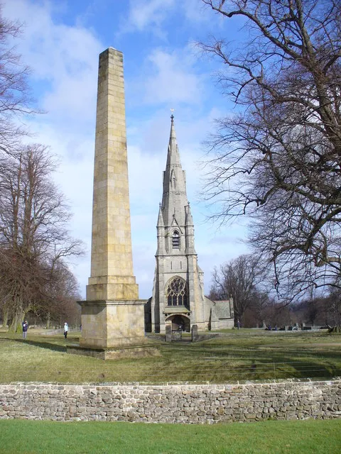 Obelisk in Studley Park, North Yorkshire, seen from the southwest, with St Mari's parish church beyond. The obelisk was erected about 1805 as a monument to Elizabeth Aislabie.