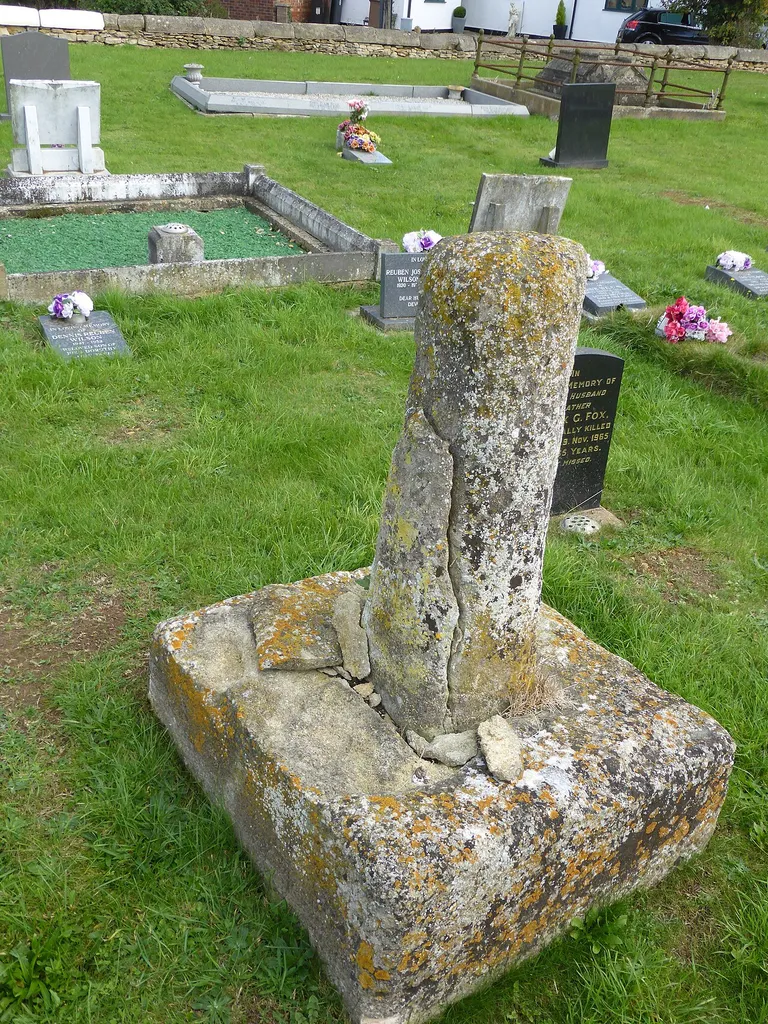 Base and broken shaft of stone churchyard cross in St Peter's parish churchyard, Threekingham, Lincolnshire