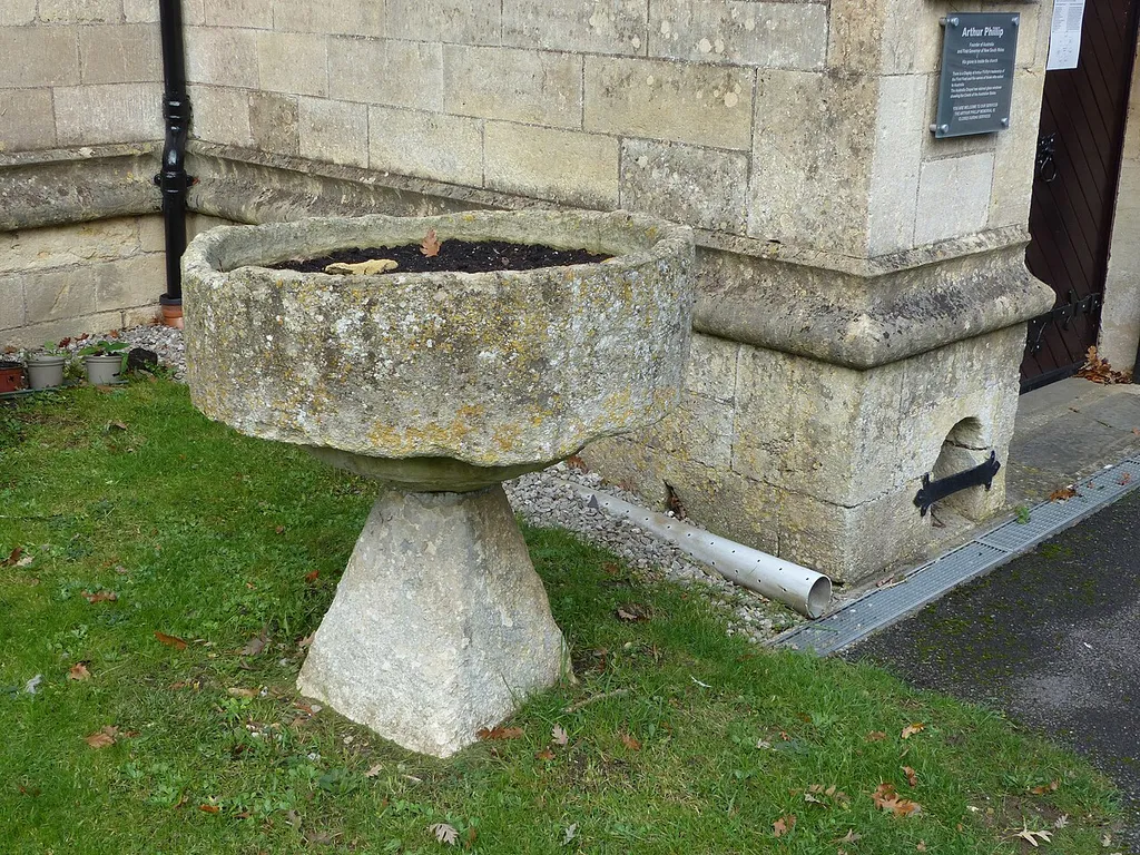 Grade II listed former font at St Nicholas' Church, Bathampton, Somerset. Listed as "Former font at south west corner of porch of Parish Church of St Nicholas". .mw-parser-output .messagebox{margin:4px 0;width:auto;border-collapse:collapse;border:2px solid var(--border-color-progressive,#6485d1);background-color:var(--background-color-neutral-subtle,#fbfcff);color:var(--color-base,#202122);box-sizing:border-box;border-inline-start-width:8px}.mw-parser-output .messagebox.mbox-small{font-size:88%;line-height:1.25em}.mw-parser-output .mbox-warning,.mw-parser-output .mbox-speedy{border:2px solid var(--border-color-error,#b22222);background:var(--background-color-error-subtle,#ffdbdb);border-inline-start-width:8px}.mw-parser-output .mbox-serious,.mw-parser-output .mbox-delete,.mw-parser-output .mbox-stop{border:2px solid var(--border-color-error,#b22222);border-inline-start-width:8px}.mw-parser-output .mbox-issue,.mw-parser-output .mbox-content{border:2px solid #f28500;background:var(--background-color-warning-subtle,#ffe);border-inline-start-width:8px}.mw-parser-output .mbox-query,.mw-parser-output .mbox-style{border:2px solid #f4c430;background:var(--background-color-warning-subtle,#ffe);border-inline-start-width:8px}.mw-parser-output .mbox-shit{border:2px solid #960;border-inline-start-width:8px}.mw-parser-output .mbox-license{border:2px solid #88a;border-inline-start-width:initial}.mw-parser-output .mbox-legal{border:2px solid var(--border-color-notice,#666);background:var(--background-color-base,#fff);border-inline-start-width:8px}.mw-parser-output .mbox-honor{border:2px solid #ca3;background:var(--background-color-warning-subtle,#fcf4db);border-inline-start-width:8px}.mw-parser-output .mbox-growth{border:2px solid #8d4;background:var(--background-color-success-subtle,#d5fdf4);border-inline-start-width:8px}.mw-parser-output .mbox-move{border:2px solid #93c;border-inline-start-width:8px}.mw-parser-output .mbox-protection,.mw-parser-output .mbox-message{border:2px sol