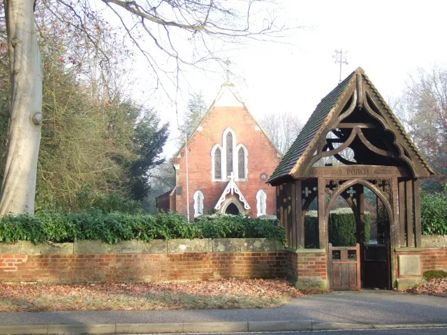 Christ Church, Longcross Road, Longcross, Surrey, seen from the south. The lychgate is a monument to Sub-Lieutenant Cyril Mullins, an aviator killed in combat in 1916.