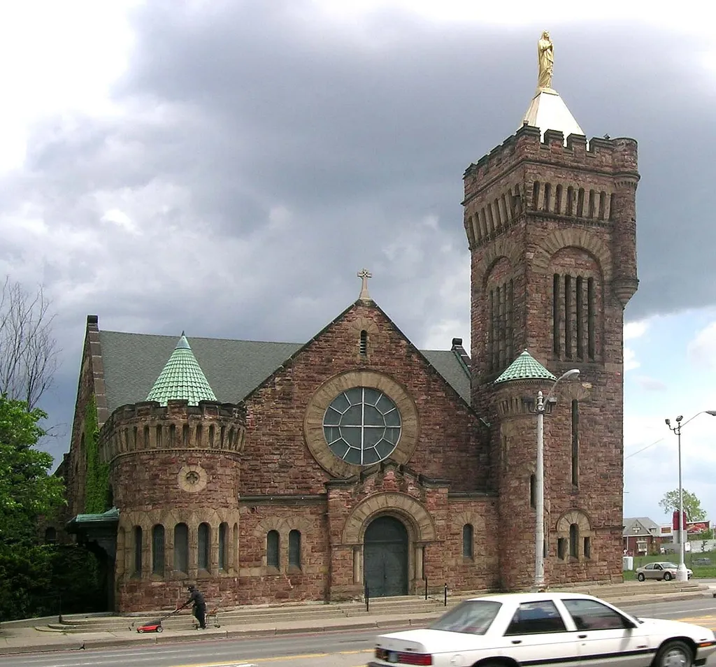 Saint Joseph's Episcopal Church on Woodward Avenue, Detroit, Michigan; the building was Saint Joseph's Episcopal Church (1893 to 1896), and Our Lady of the Rosary Roman Catholic Church (1907 to present), a Romanesque revival Richardsonian Romanesque style.