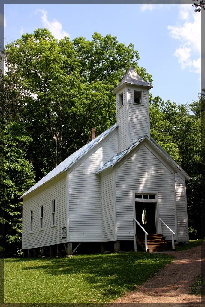 "In Cades Cove as in the rest of the Smokies, Baptists were divided into camps of members who supported missionary work, temperance societies and Sunday schools and those that didn't. Some thought there was no Biblical support for those things. In the end, a number of Cades Cove Baptists were eventually dismissed from the original Baptist church for their beliefs including Johnson Adams who was pastor. On May 15, 1841, Adams and other disenfranchised Smokies pioneers banded together and established the Cades Cove Missionary Baptist Church. The start was rocky. They had no meeting house and had to meet in individual homes. Sometimes they made arrangements to meet at the Primitive Baptist or Methodist church buildings. Also, in the Smokies there was much confusion over the Civil War. During the Civil War and reconstruction, the Missionary Baptists didn't meet for long periods of time. After the war however, they had a particularly successful revival and were able to erect their own church building in the Cades Cove area of the Smoky Mountains. Their church was constructed on Hyatt Hill in 1894, with their rolls bulging with 40 members. Eventually the rolls grew to over one hundred. In 1915, a new building was needed and was created in the present location."