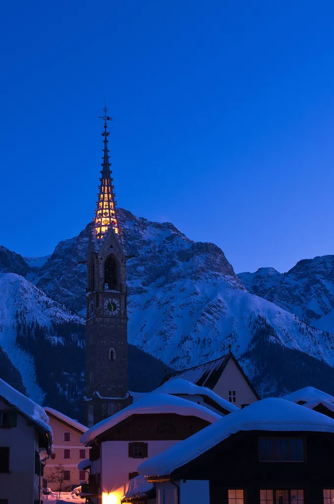 Evangelic church at sundown in a winter's night in Sent GR (CH)